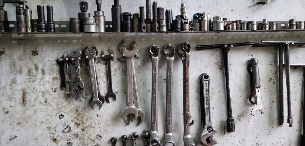 a bunch of tools are hanging on a wall