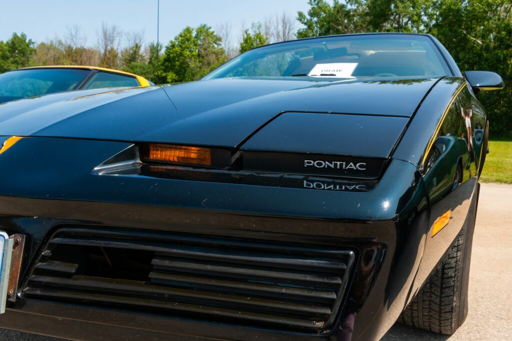 a black sports car parked next to a yellow sports car