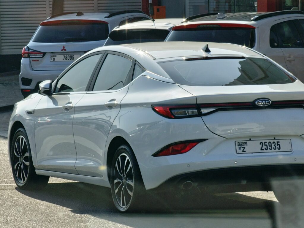 a white car parked in a lot next to other cars