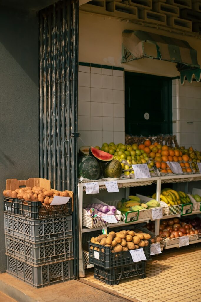 A fruit stand on the side of a street