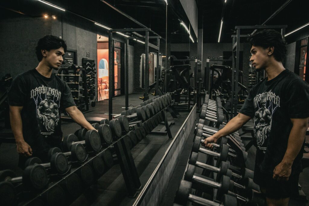 A couple of men standing next to each other in a gym