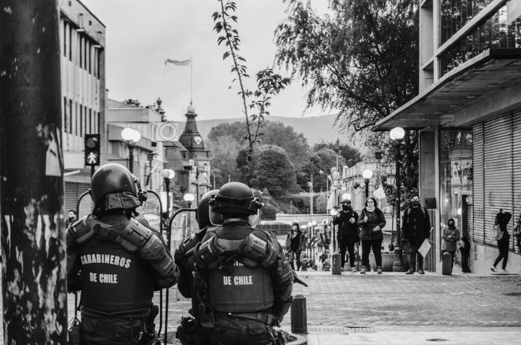 grayscale photography of police wearing armors in the street