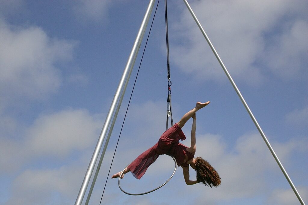 A woman is doing a trick on a pole