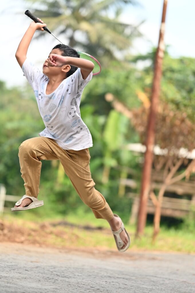 a man jumping in the air while holding a baseball bat