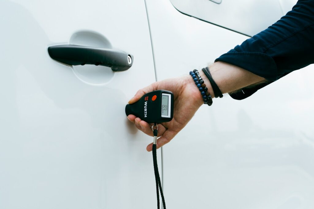 A person is holding a car door handle