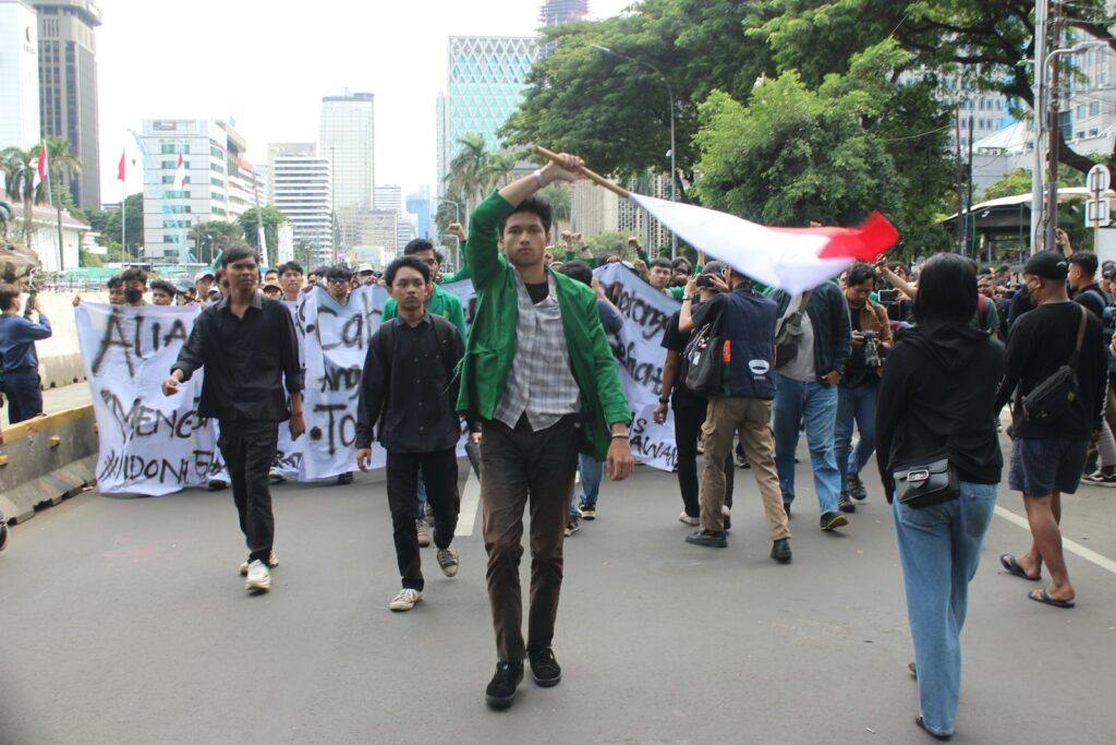 A group of people walking down a street