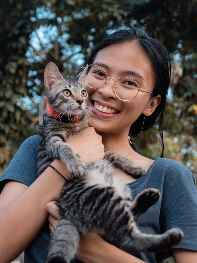 a woman holding a cat in her arms