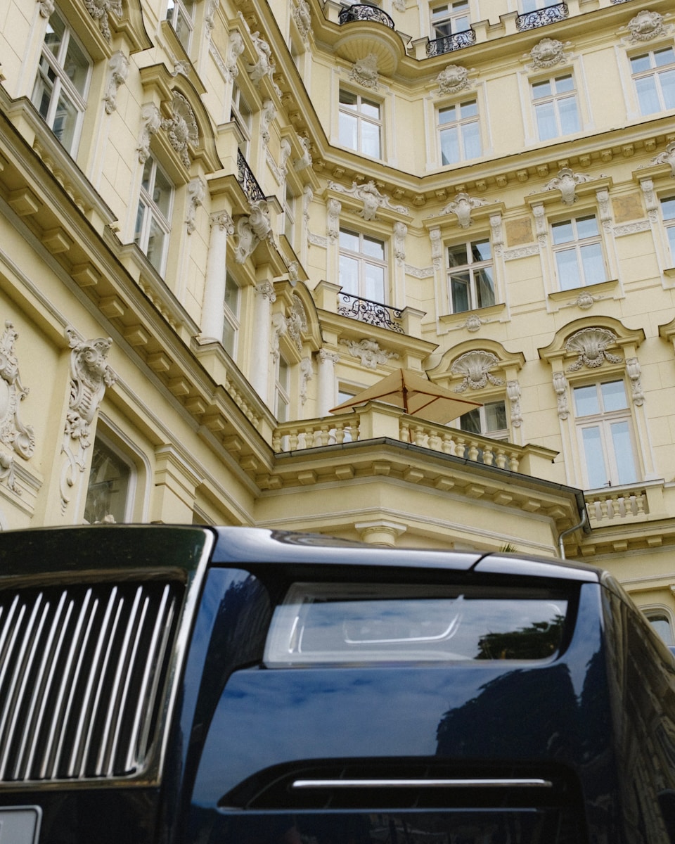 A black truck parked in front of a tall building