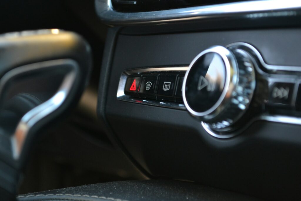 Car's interior controls, including hazard lights.