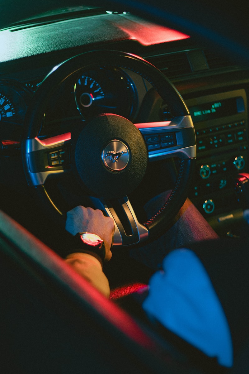 A person sitting in a car with a steering wheel