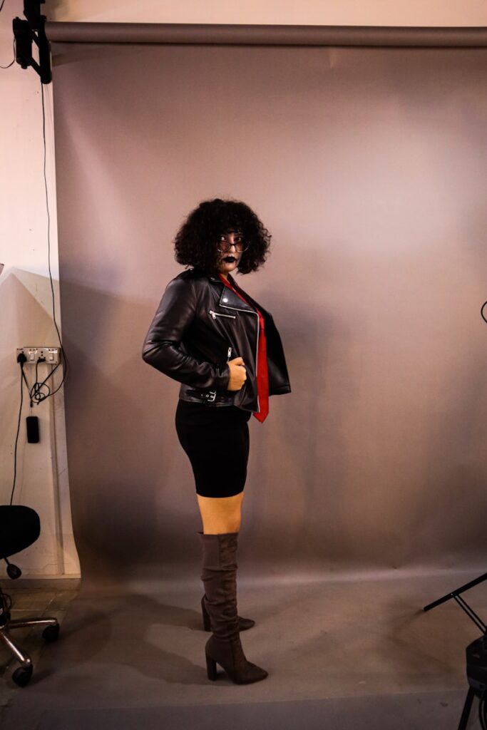 a woman in a black leather jacket and yellow tights
