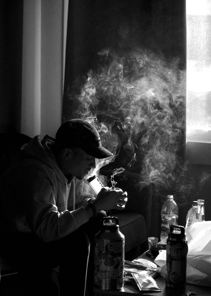 man in white dress shirt smoking cigarette