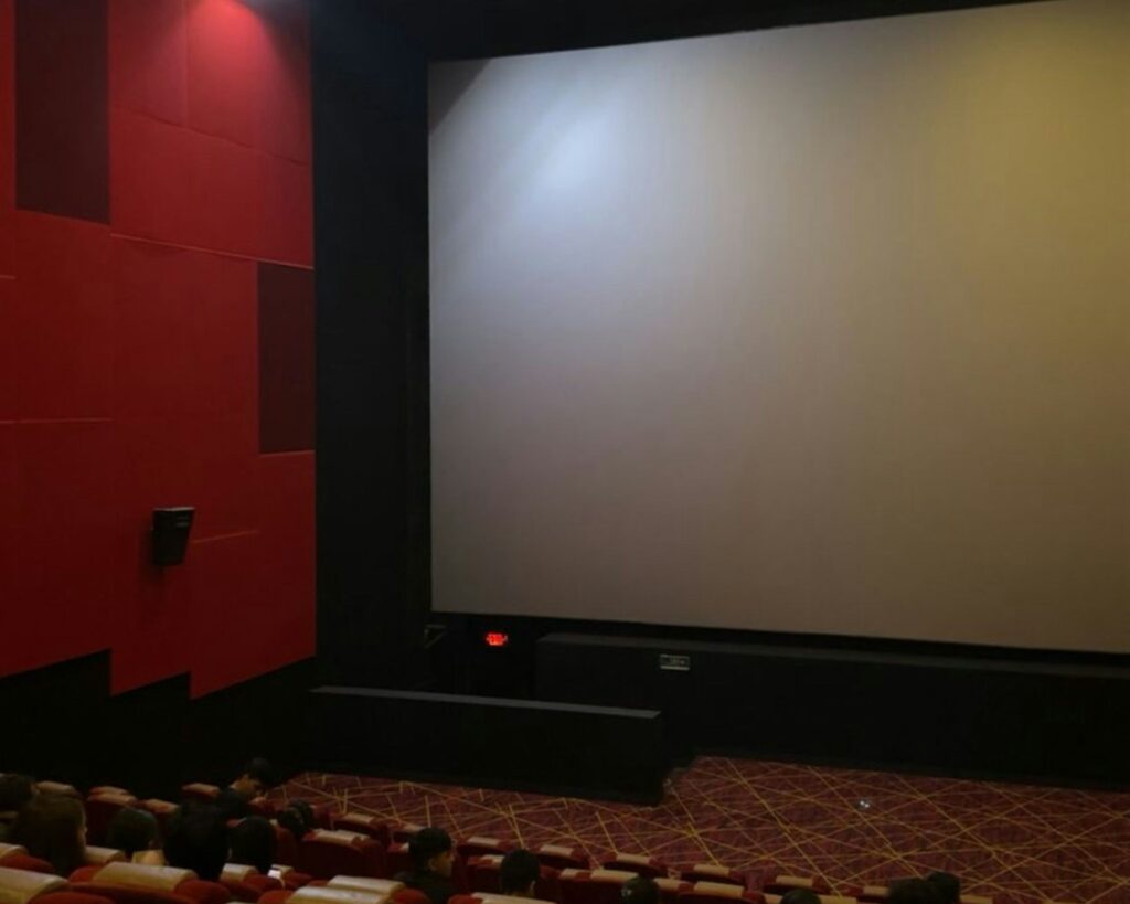 Empty movie theater screen awaiting a film.