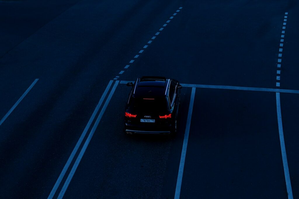 black car on road during night time