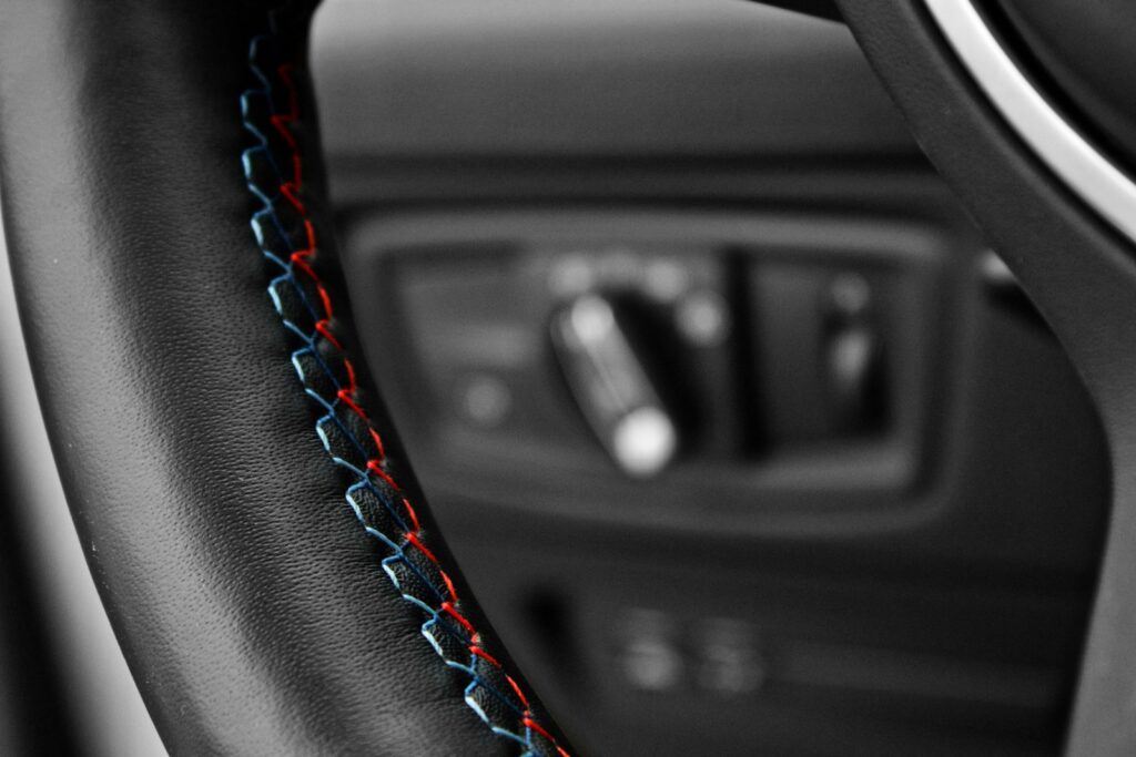 black car steering wheel in close up photography