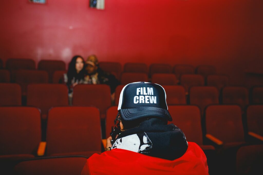 A person sitting in a red chair in front of a red wall