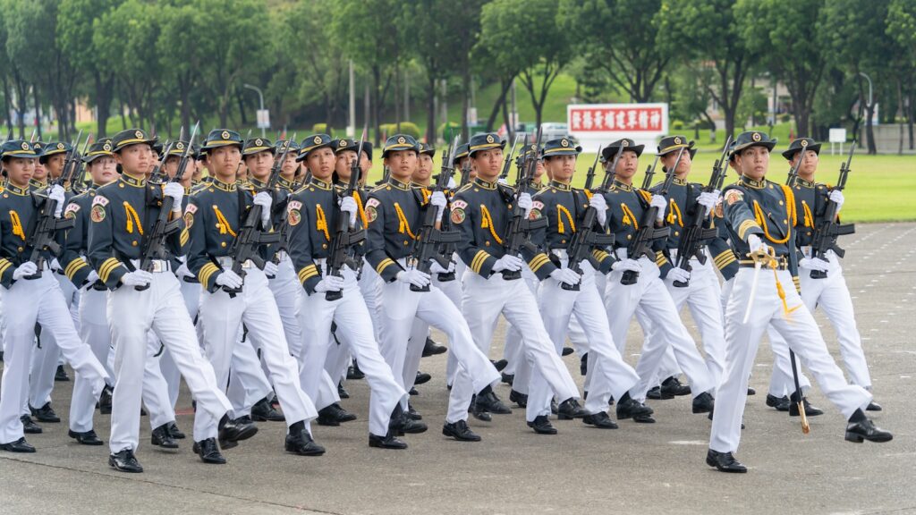 A group of men in uniform marching down a street