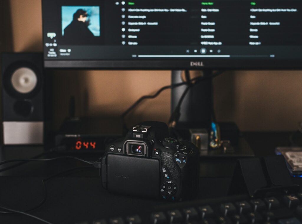 black canon dslr camera on black computer keyboard
