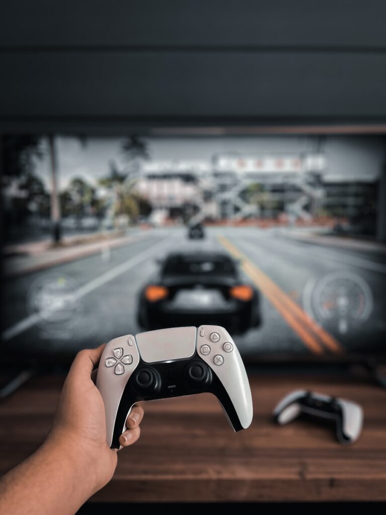 a person holding a video game controller in front of a tv