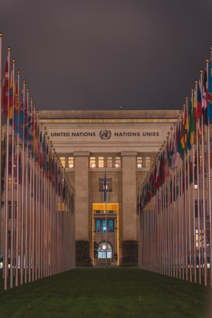 A large building with many flags in front of it
