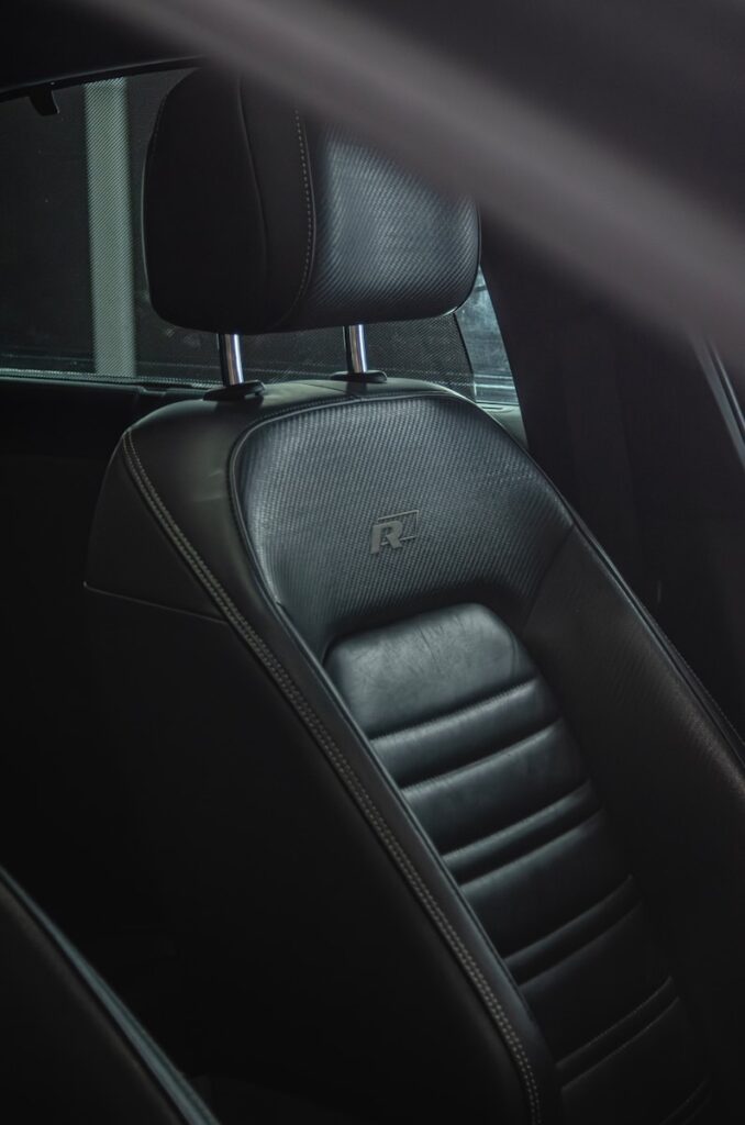 the interior of a car with black leather