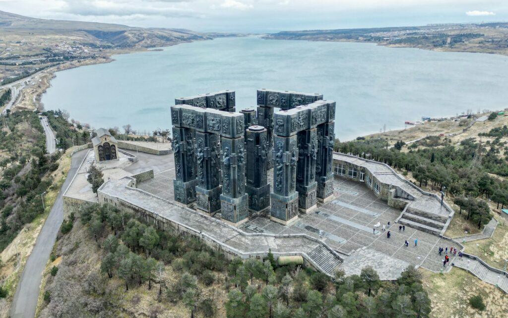 an aerial view of a castle with a lake in the background