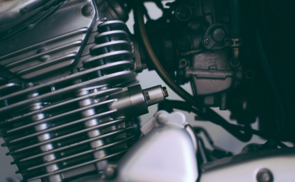 Detailed close-up of a shiny motorcycle engine showcasing metal components.