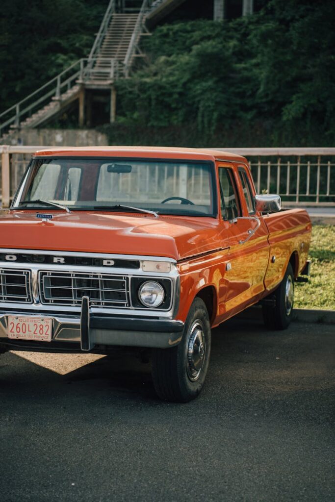 Classic red Ford pickup truck parked outdoors, vintage vehicle perfect for collectors.