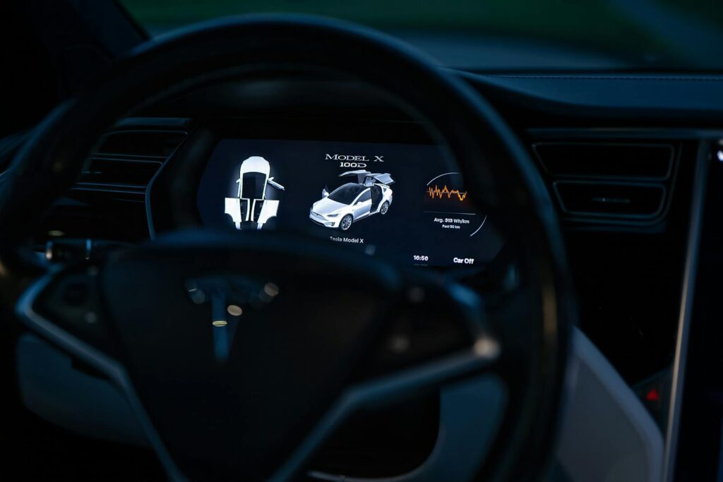 Close-up of a Tesla Model X dashboard display, showcasing advanced technology features.