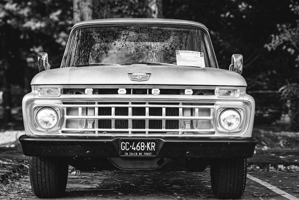 Classic Ford F-Series truck front view, black and white, capturing vintage charm.