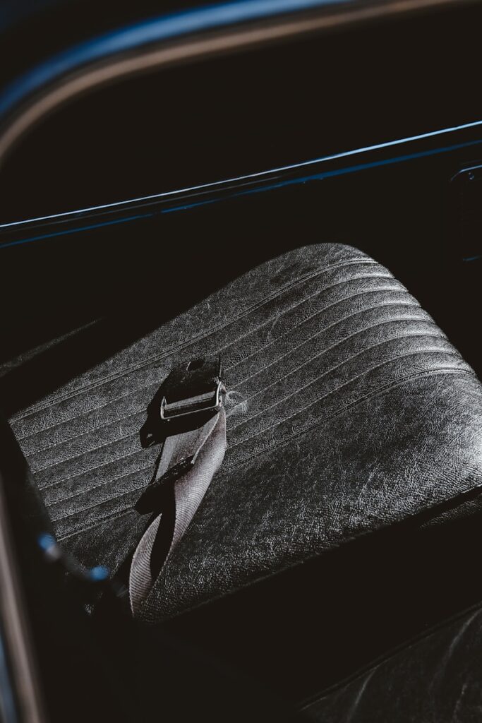 A car seat and seatbelt are shown.