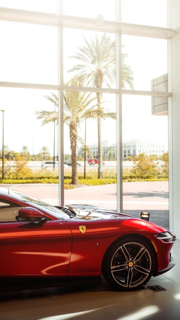 a red sports car parked in front of a window