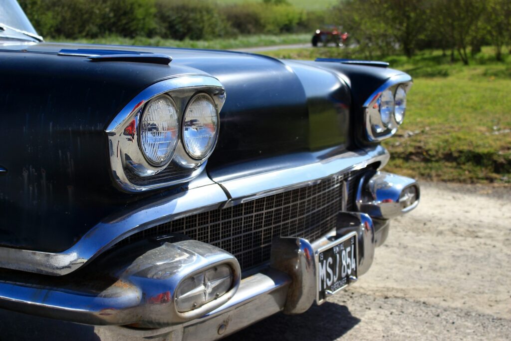 blue classic car on road during daytime