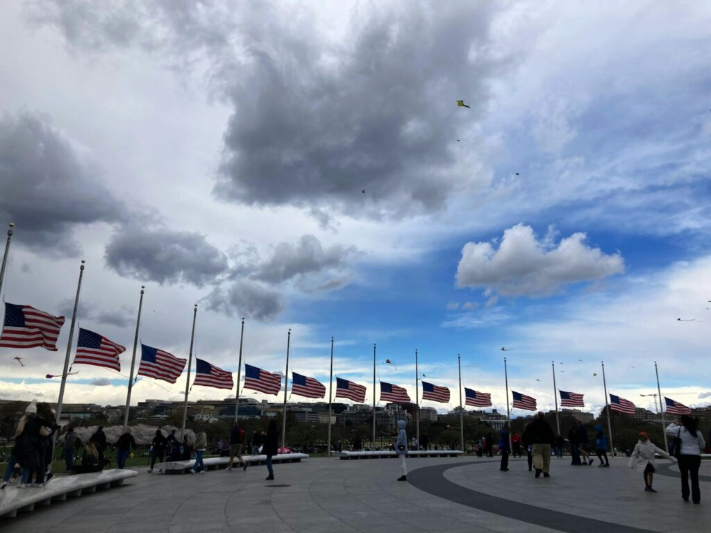 A group of people walking around a parking lot