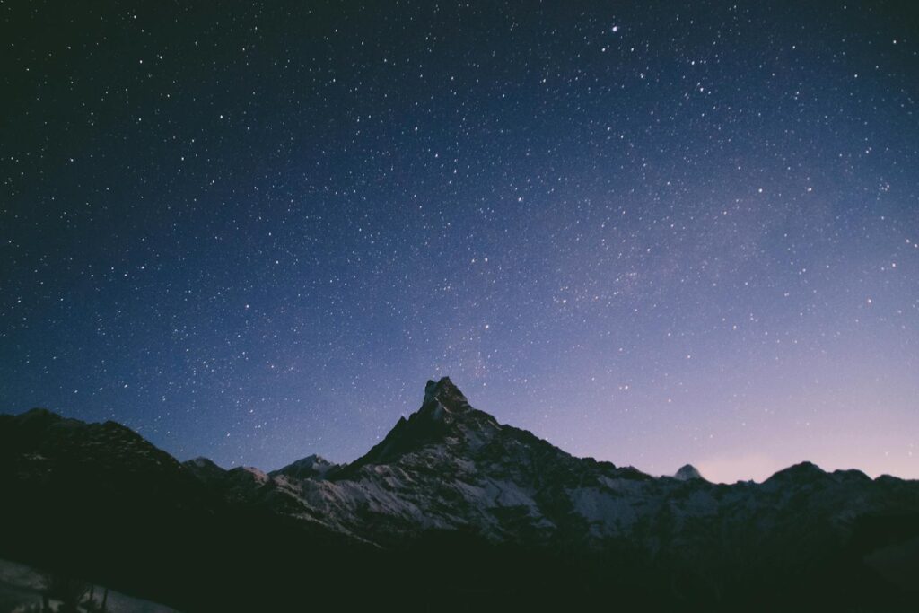 Starry night sky over snow-capped Annapurna range in Nepal's Western Development Region.