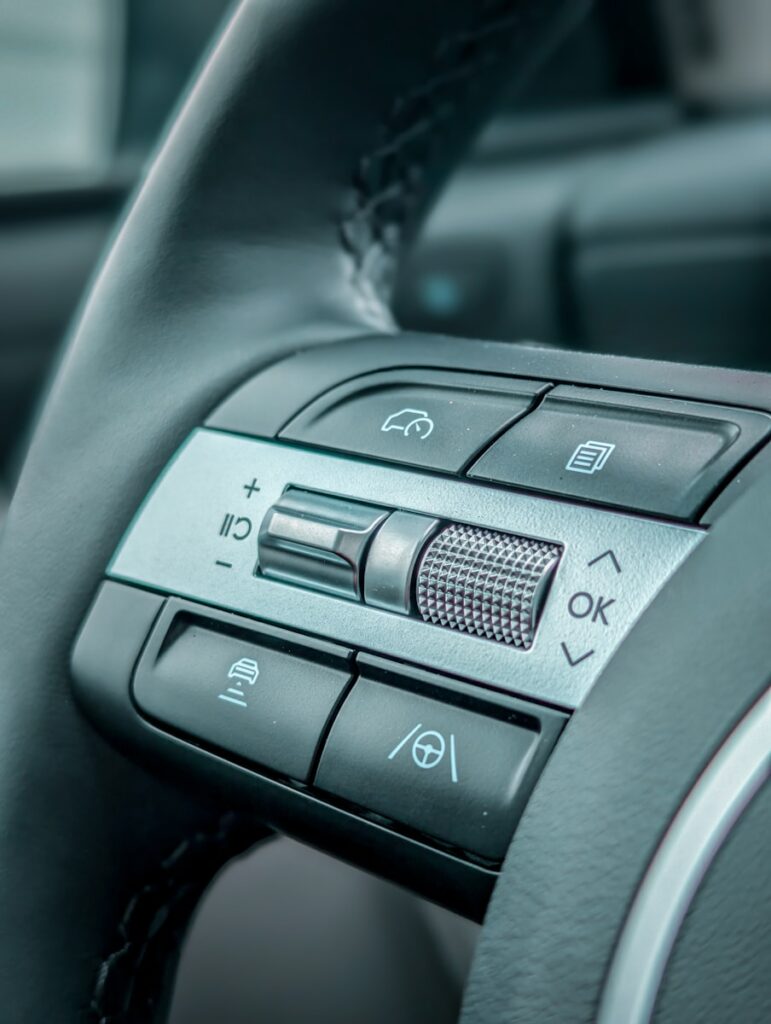Close-up of a modern car steering wheel controls.