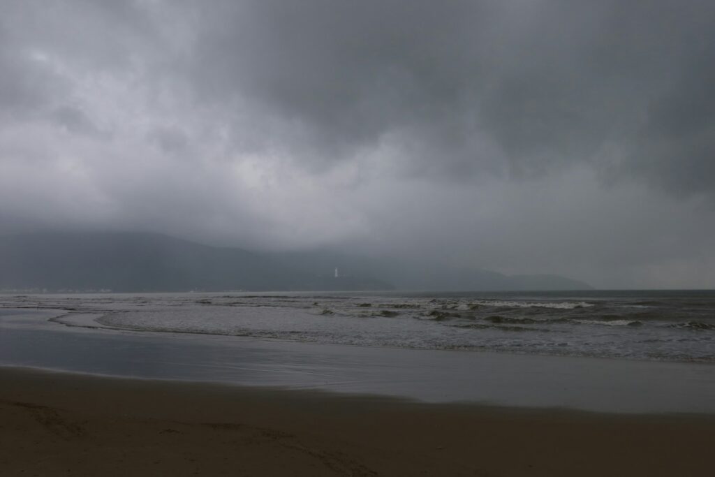a large body of water under a cloudy sky