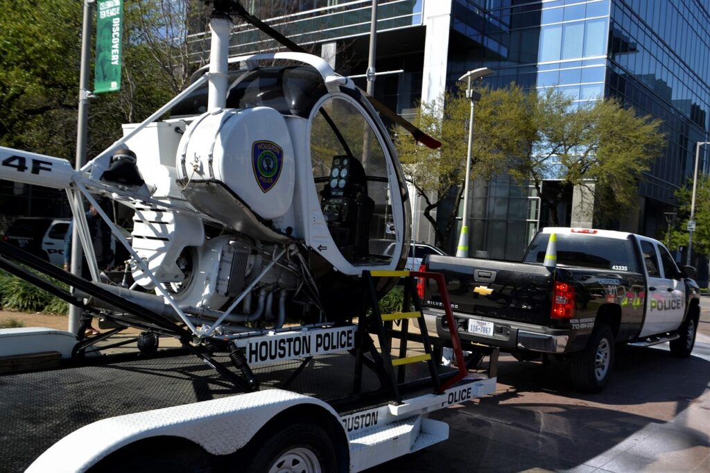 police helicopter, aviation, flight, car, transportation system, vehicle, street, road, transportation, transport, motion, travel, outdoor, danger, modern, safety, city, motor, tire, automobile, light, office building, tree, rescue, badge, honor, respect, protection, protector, patrol, lift, towing, tow, pick-up truck, chopper, aerial, flying, exterior, white, blue, black, green, sunny, day time, daylight, windows, rutter, propeller, hitch, drive, driving, pull, attached, car wallpapers, attachment, nature, truck, adventure, automotive, journey, trip, service, summer, auto, coast guard, alert, 911, emergency, unit, squad, flyer, police car, squad cars, task force, pct, houston, texas, houston police department, parked, stationary, waiting, unmanned, empty, black and white, suv, sports utility vehicle, 4x4, race, chevy, sirens, warning, control, assistance, monitoring, surveillance, job, government, official, arrested, arrest, robbery
