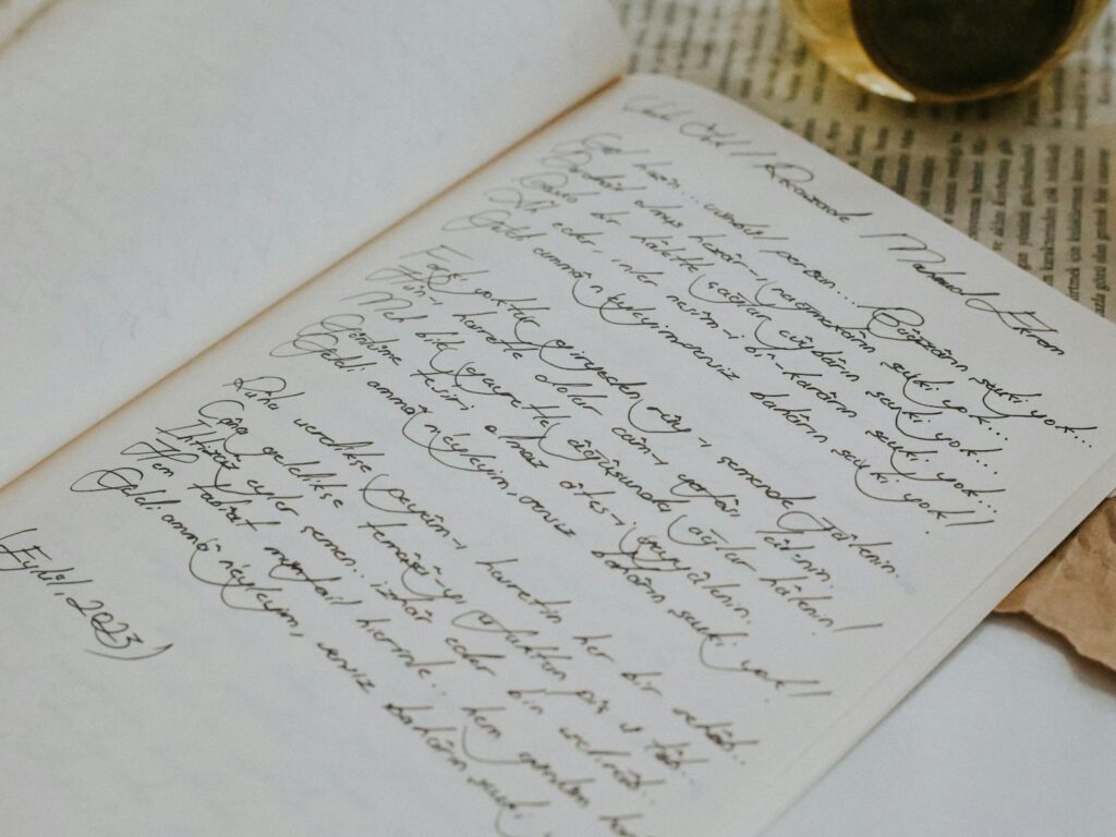 Close-up of elegant handwriting on an open notebook with a vintage aesthetic.