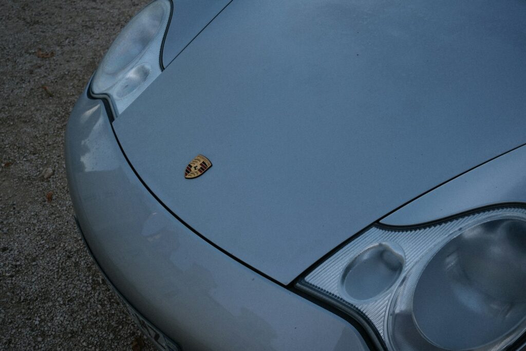 Silver porsche hood with emblem and emblem