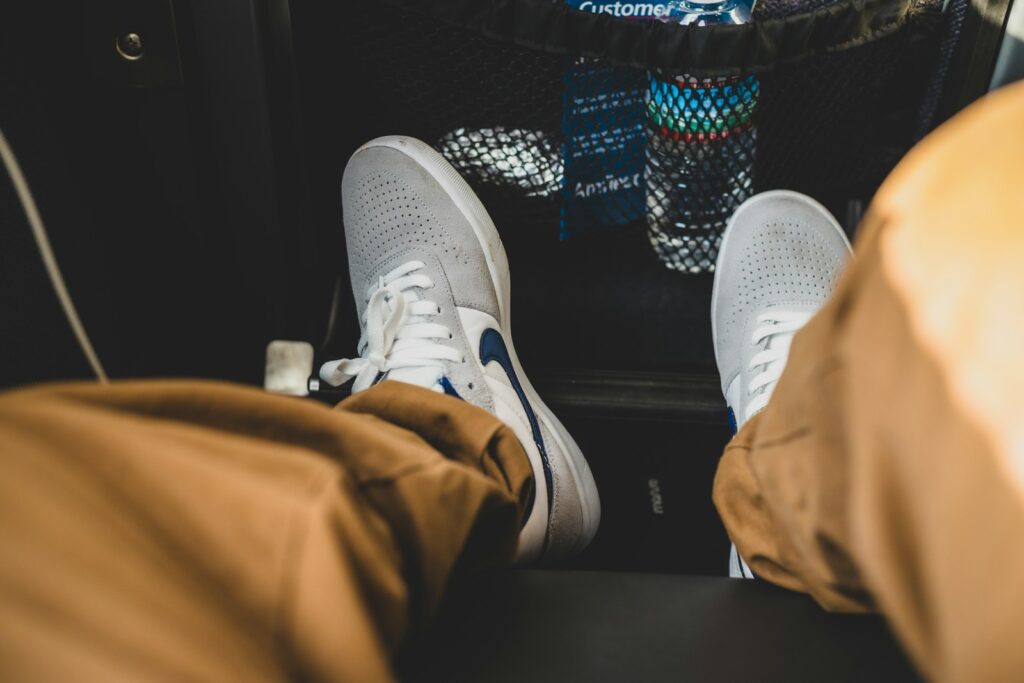 person wearing gray and white nike sneakers