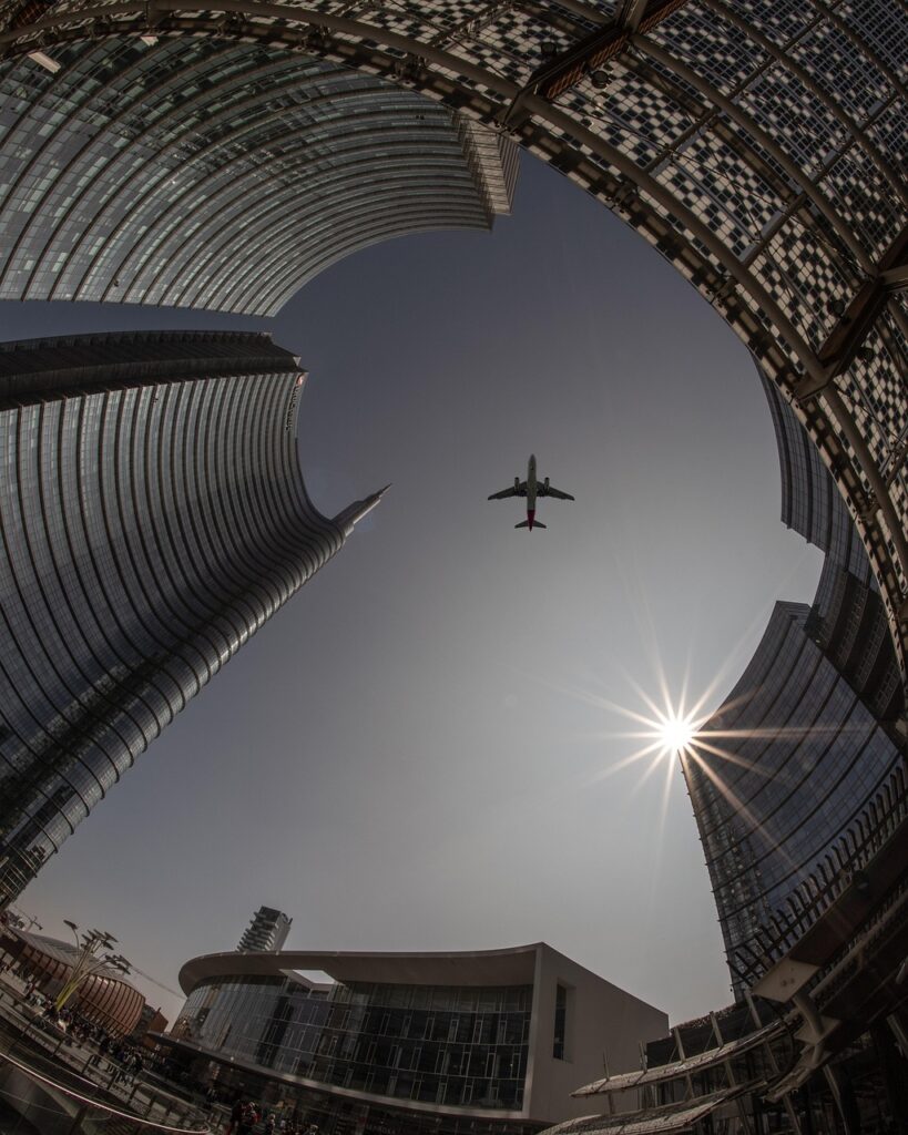 plane, city, architecture, sky, airplane, flight, travel, sun, urban, buildings, tourism, outdoors, transportation, nature, cityscape, skyline, tower, skyscrapers, lookup, aircraft