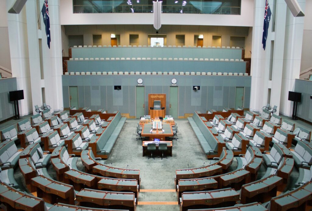 a large room with rows of chairs and a podium