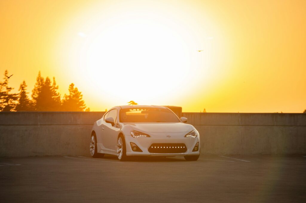 a white sports car parked in a parking lot