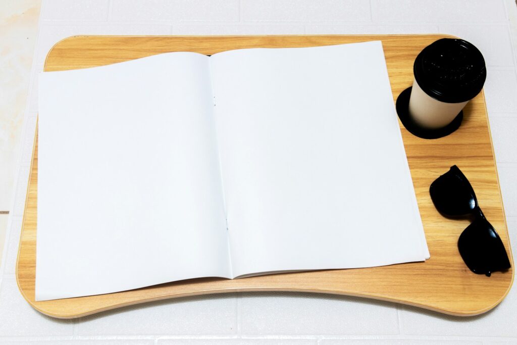 an open book sitting on top of a wooden tray