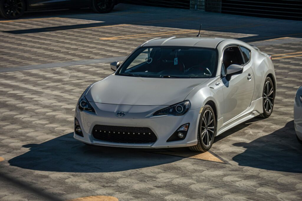 a white sports car parked in a parking lot
