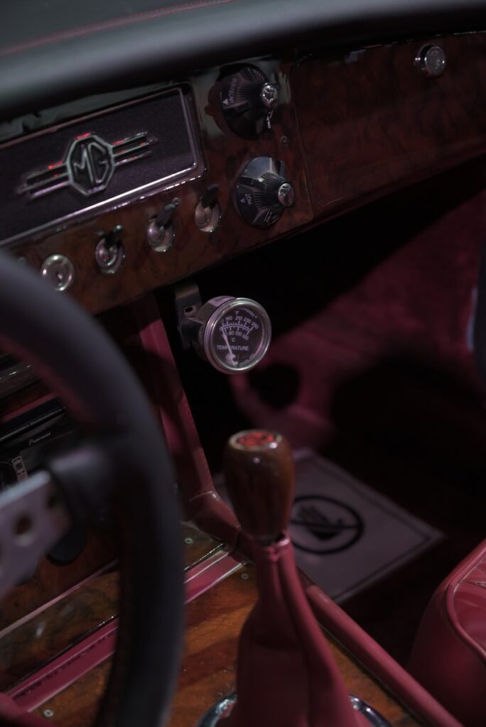 The interior of a car with a steering wheel and dashboard
