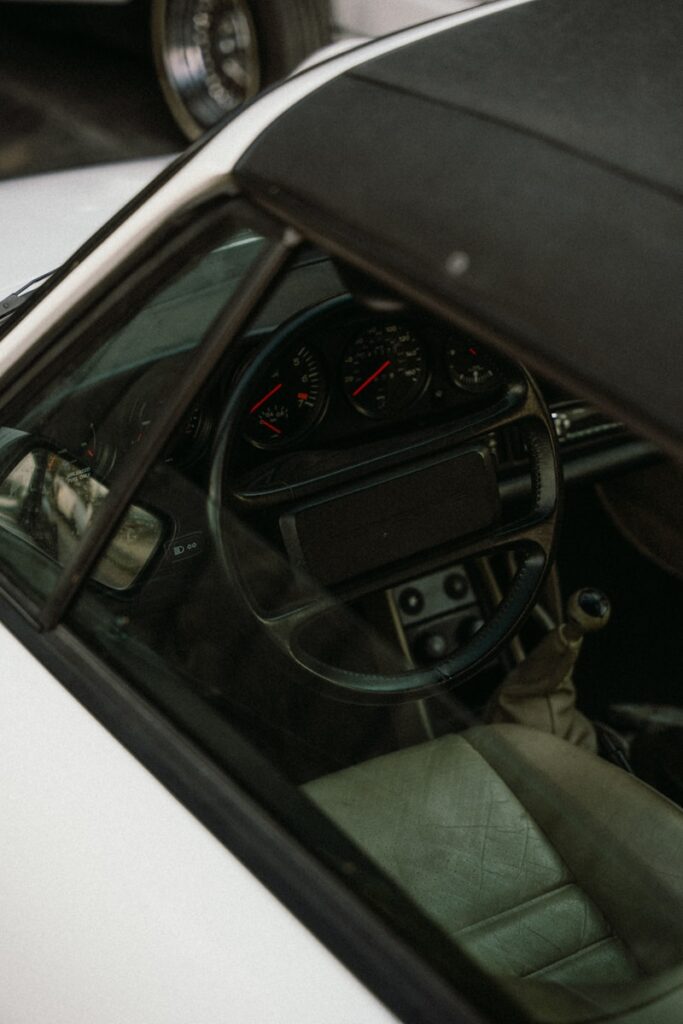 The interior of a car with a steering wheel and dashboard