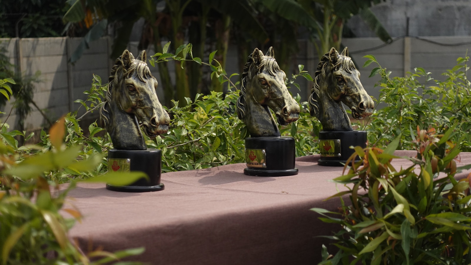 A table topped with lots of statues of horses