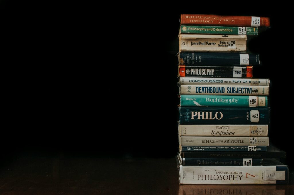 a stack of books sitting on top of a wooden table